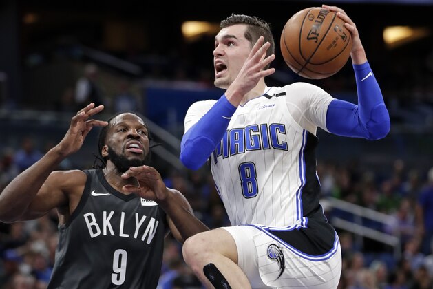 Orlando Magic's Mario Hezonja (8) goes up for a shot against Brooklyn Nets' DeMarre Carroll (9) during the first half of an NBA basketball game, Wednesday, March 28, 2018, in Orlando, Fla. (AP Photo/John Raoux)