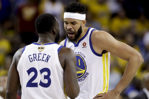 Golden State Warriors forward Draymond Green (23) talks with center JaVale McGee (1) during the second half of Game 1 of basketball's NBA Finals against the Cleveland Cavaliers in Oakland, Calif., Thursday, May 31, 2018. (AP Photo/Marcio Jose Sanchez)
