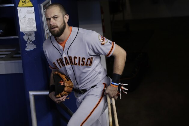 San Francisco Giants third baseman Evan Longoria walks to the dugout before a baseball game against the Miami Marlins, Thursday, June 14, 2018, in Miami. (AP Photo/Lynne Sladky)