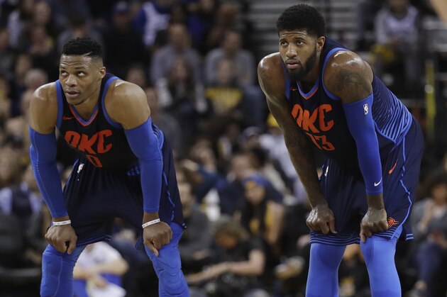 Oklahoma City Thunder's Paul George, right, and Russell Westbrook during the first half of an NBA basketball game against the Golden State Warriors Saturday, Feb. 24, 2018, in Oakland, Calif. (AP Photo/Marcio Jose Sanchez)