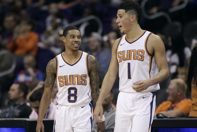 Phoenix Suns' Tyler Ulis (8) and Devin Booker talk as they walk back on to the court following a timeout during an NBA basketball exhibition game against Australia's Brisbane Bullets Friday, Oct. 13, 2017, in Phoenix. The Suns defeated the Bullets 114-93. (AP Photo/Ralph Freso)