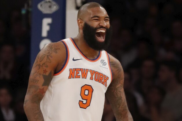 NEW YORK, NY - APRIL 6:  Kyle O'Quinn #9 of the New York Knicks reacts laughing after he sunk a three point shot in an NBA basketball game against the Miami Heat on April 6, 2018 at Madison Square Garden in New York City. Knicks won 122-98. NOTE TO USER: User expressly acknowledges and agrees that, by downloading and/or using this Photograph, user is consenting to the terms and conditions of the Getty License agreement. Mandatory Copyright Notice (Photo by Paul Bereswill/Getty Images) *** Local Caption *** Kyle O'Quinn