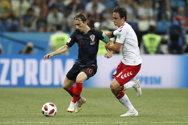 Croatia's Luka Modric, left, and Denmark's Thomas Delaney challenge for the ball during the round of 16 match between Croatia and Denmark at the 2018 soccer World Cup in the Nizhny Novgorod Stadium, in Nizhny Novgorod , Russia, Sunday, July 1, 2018. (AP Photo/Efrem Lukatsky)