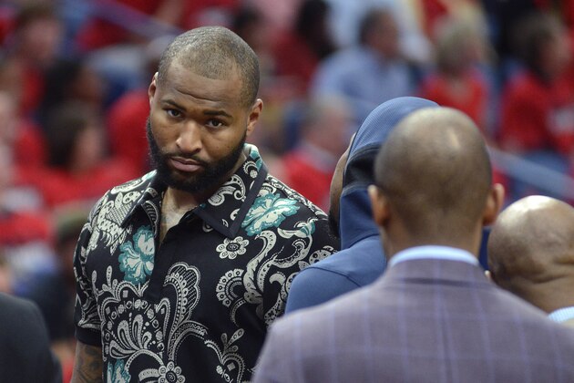 New Orleans Pelicans center DeMarcus Cousins walks on the court in street clothes during the first half of Game 3 of the team's first-round NBA basketball playoff series against the Portland Trail Blazers in New Orleans, Thursday, April 19, 2018. (AP Photo/Veronica Dominach)