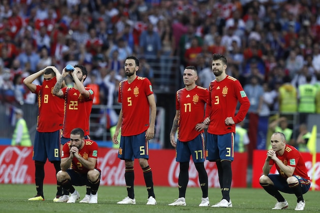 Spain's Andres Iniesta, right, watches with teammates after Spain were defeated in a penalty shoot out by Russia in the round of 16 match between Spain and Russia at the 2018 soccer World Cup at the Luzhniki Stadium in Moscow, Russia, Sunday, July 1, 2018. (AP Photo/Manu Fernandez)