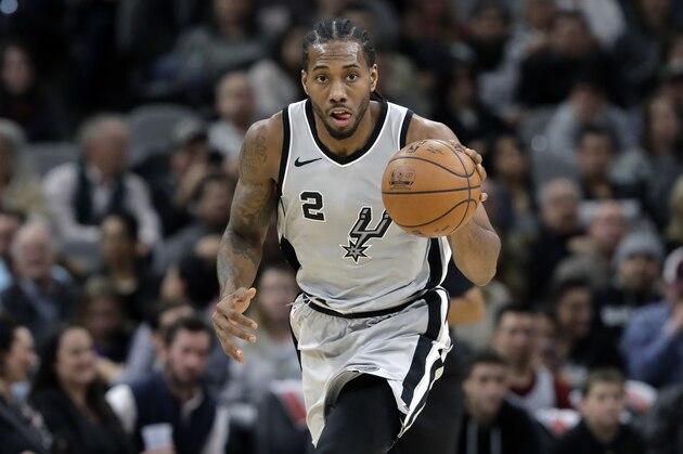 San Antonio Spurs forward Kawhi Leonard (2) moves the ball up court during the second half of an NBA basketball game against the Denver Nuggets, Saturday, Jan. 13, 2018, in San Antonio. San Antonio won 112-80. (AP Photo/Eric Gay)