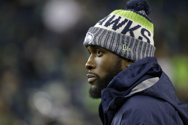 Injured Seattle Seahawks strong safety Kam Chancellor stands on the field before an NFL football game against the Atlanta Falcons, Monday, Nov. 20, 2017, in Seattle. (AP Photo/Ted S. Warren)