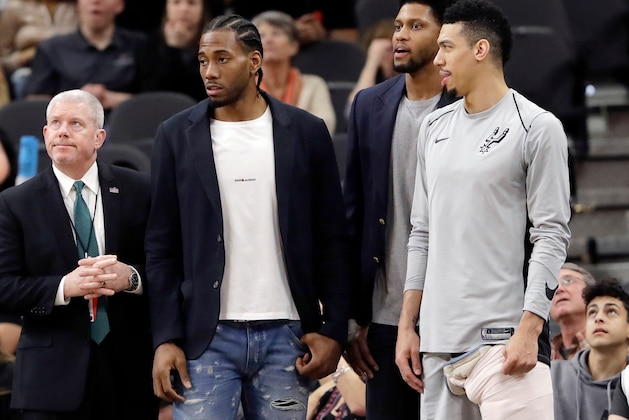 FILE - In this Jan. 21, 2018, file photo, San Antonio Spurs guard Danny Green, right, stands at the bench with injured teammates Kawhi Leonard, second from left, and Rudy Gay, center, during the second half of an NBA basketball game against the Indiana Pacers in San Antonio. The absolute unwillingness to answer certain questions is part of the San Antonio Spurs' mystique. The Spurs just don't share much. So there is some unmistakable irony here that when it comes to the obviously fractured relationship between San Antonio and Kawhi Leonard, it's the Spurs who are the ones frustrated by the lack of answers. (AP Photo/Eric Gay, File)