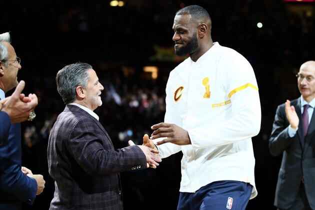 CLEVELAND, OH - OCTOBER 25: LeBron James #23 of the Cleveland Cavaliers recieves his championship ring from owner Dan Gilbert before the game against the New York Knicks at Quicken Loans Arena on October 25, 2016 in Cleveland, Ohio.   NOTE TO USER: User expressly acknowledges and agrees that, by downloading and or using this photograph, User is consenting to the terms and conditions of the Getty Images License Agreement. (Photo by Ezra Shaw/Getty Images)