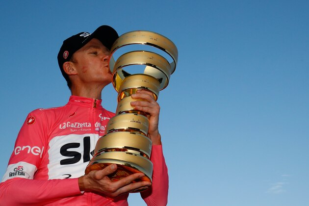 Pink jersey and winner, Britain's rider of team Sky Christopher Froome, kisses the trophy on the podium after the 21st and last stage of the 101st Giro d'Italia, Tour of Italy cycling race, on May 27, 2018 in Rome. - Britain's Chris Froome completed a sensational comeback to win the Giro d'Italia on Sunday for a rare Grand Tour treble after the 21st and final stage in Rome. Froome, 33, became the first Briton to win the race in the Giro's 101-year history after the 115km closed circuit race through the streets of the Italian capital. (Photo by LUK BENIES / AFP)        (Photo credit should read LUK BENIES/AFP/Getty Images)