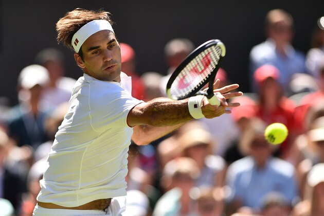Switzerland's Roger Federer returns to Serbia's Dusan Lajovic during their men's singles first round match on the first day of the 2018 Wimbledon Championships at The All England Lawn Tennis Club in Wimbledon, southwest London, on July 2, 2018. (Photo by Glyn KIRK / AFP) / RESTRICTED TO EDITORIAL USE        (Photo credit should read GLYN KIRK/AFP/Getty Images)