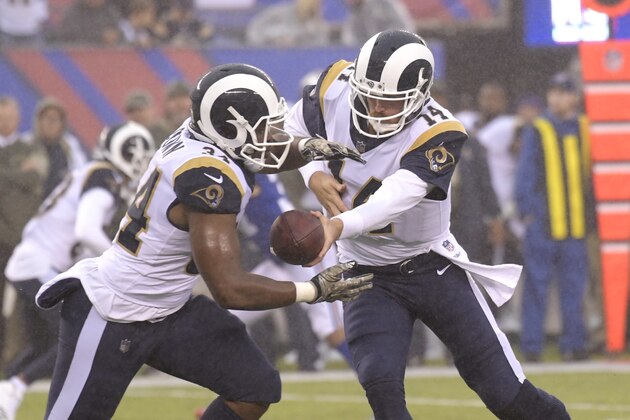 Los Angeles Rams quarterback Sean Mannion, right, hands the ball off to Los Angeles Rams running back Malcolm Brown during the second half of an NFL football game Sunday, Nov. 5, 2017, in East Rutherford, N.J. (AP Photo/Bill Kostroun)
