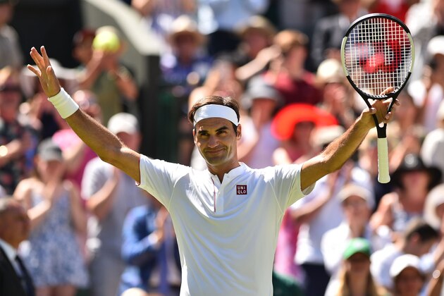 Switzerland's Roger Federer celebrates after beating Serbia's Dusan Lajovic 6-1, 6-3, 6-4 in their men's singles first round match on the first day of the 2018 Wimbledon Championships at The All England Lawn Tennis Club in Wimbledon, southwest London, on July 2, 2018. (Photo by Glyn KIRK / AFP) / RESTRICTED TO EDITORIAL USE        (Photo credit should read GLYN KIRK/AFP/Getty Images)