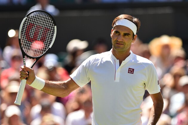 Switzerland's Roger Federer celebrates after beating Serbia's Dusan Lajovic 6-1, 6-3, 6-4 in their men's singles first round match on the first day of the 2018 Wimbledon Championships at The All England Lawn Tennis Club in Wimbledon, southwest London, on July 2, 2018. (Photo by Glyn KIRK / AFP) / RESTRICTED TO EDITORIAL USE        (Photo credit should read GLYN KIRK/AFP/Getty Images)