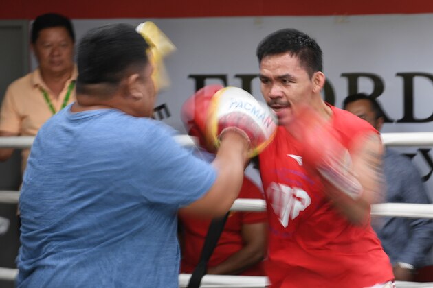 This photo taken on May 17, 2018 shows Philippine boxing icon Manny Pacquiao (R) sparring with his childhood friend and long-time assistant trainer Buboy Fernandez during a training session at a gym in Manila, ahead of his world welterweight boxing championship bout against Argentina's Lucas Matthysse in July. (Photo by TED ALJIBE / AFP)        (Photo credit should read TED ALJIBE/AFP/Getty Images)