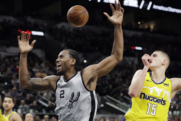 San Antonio Spurs forward Kawhi Leonard (2) reacts after he was fouled by Denver Nuggets center Nikola Jokic (15) during the second half of an NBA basketball game Saturday, Jan. 13, 2018, in San Antonio. San Antonio won 112-80. (AP Photo/Eric Gay)
