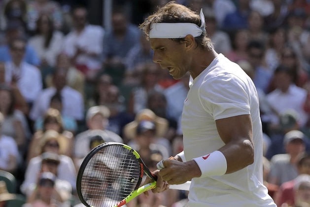 Rafael Nadal, of Spain celebrates winning a point in his men's singles match, against Dudi Sela, of Israel, on the second day of the Wimbledon Tennis Championships in London, Tuesday July 3, 2018. (AP Photo/Ben Curtis)
