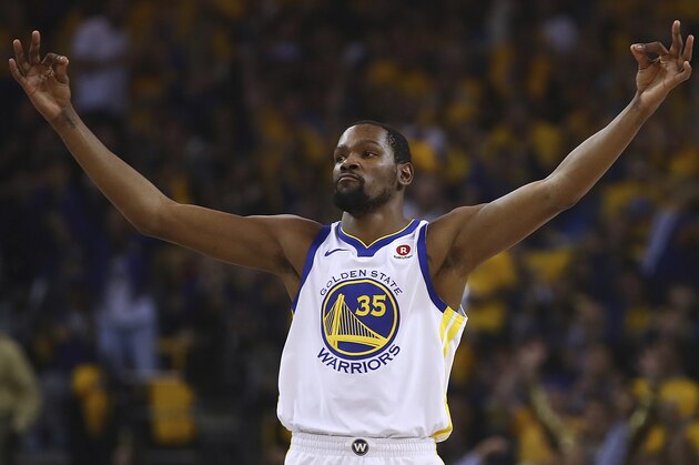 Golden State Warriors' Kevin Durant celebrates a score against the San Antonio Spurs during the first quarter in Game 5 of a first-round NBA basketball playoff series Tuesday, April 24, 2018, in Oakland, Calif. (AP Photo/Ben Margot)