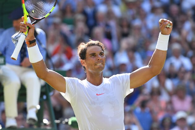 Spain's Rafael Nadal celebrates after beating Israel's Dudi Sela 6-3, 6-3, 6-2 in their men's singles first round match on the second day of the 2018 Wimbledon Championships at The All England Lawn Tennis Club in Wimbledon, southwest London, on July 3, 2018. (Photo by Ben STANSALL / AFP) / RESTRICTED TO EDITORIAL USE        (Photo credit should read BEN STANSALL/AFP/Getty Images)