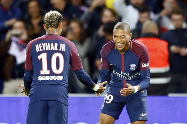 Paris Saint Germain's Kylian Mbappe, right, reacts with Neymar after he scored the second goal against Lyon during their French League One soccer match between PSG and Olympique Lyon at the Parc des Princes stadium in Paris, France, Sunday, Sept. 17, 2016. (AP Photo/Francois Mori)