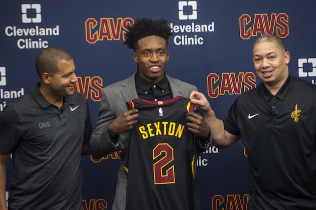 Cleveland Cavaliers first round draft selection, Collin Sexton, center, displays his jersey with Cavaliers general manager Koby Altman, left and Cavaliers head coach Tyronn Lue during a news conference at the Cavaliers training facility in Independence, Ohio, Friday, June 22, 2018.  (AP Photo/Phil Long)