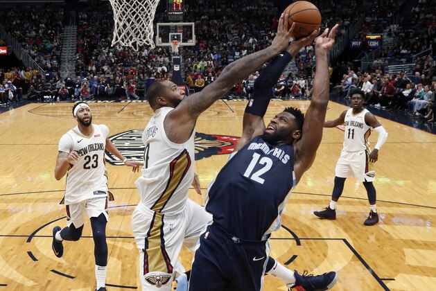 New Orleans Pelicans center DeMarcus Cousins (0) blocks a shot by Memphis Grizzlies guard Tyreke Evans (12) in the second half of an NBA basketball game in New Orleans, Saturday, Jan. 20, 2018. (AP Photo/Gerald Herbert)