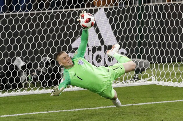 England goalkeeper Jordan Pickford stops a penalty shot from Colombia's Carlos Bacca during the round of 16 match between Colombia and England at the 2018 soccer World Cup in the Spartak Stadium, in Moscow, Russia, Tuesday, July 3, 2018. (AP Photo/Antonio Calanni)