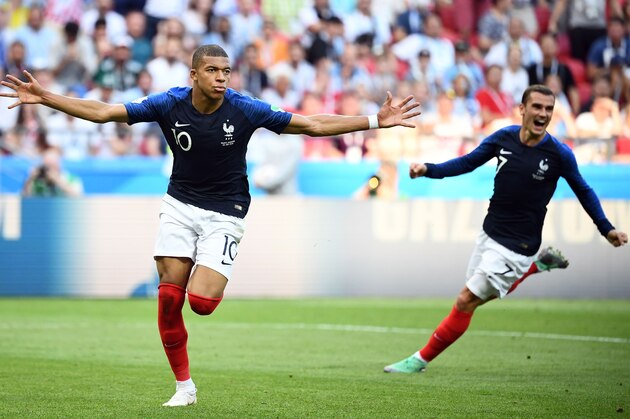 TOPSHOT - France's forward Kylian Mbappe (L) celebrates past France's forward Antoine Griezmann after scoring their fourth goal during the Russia 2018 World Cup round of 16 football match between France and Argentina at the Kazan Arena in Kazan on June 30, 2018. (Photo by FRANCK FIFE / AFP) / RESTRICTED TO EDITORIAL USE - NO MOBILE PUSH ALERTS/DOWNLOADS        (Photo credit should read FRANCK FIFE/AFP/Getty Images)