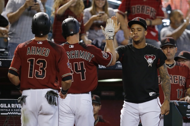 Arizona Diamondbacks' Paul Goldschmidt, middle, celebrates his two-run home run against the San Francisco Giants with Ketel Marte, right, and Nick Ahmed (13) during the seventh inning of a baseball game Sunday, July 1, 2018, in Phoenix. The Giants defeated the Diamondbacks 9-6. (AP Photo/Ross D. Franklin)