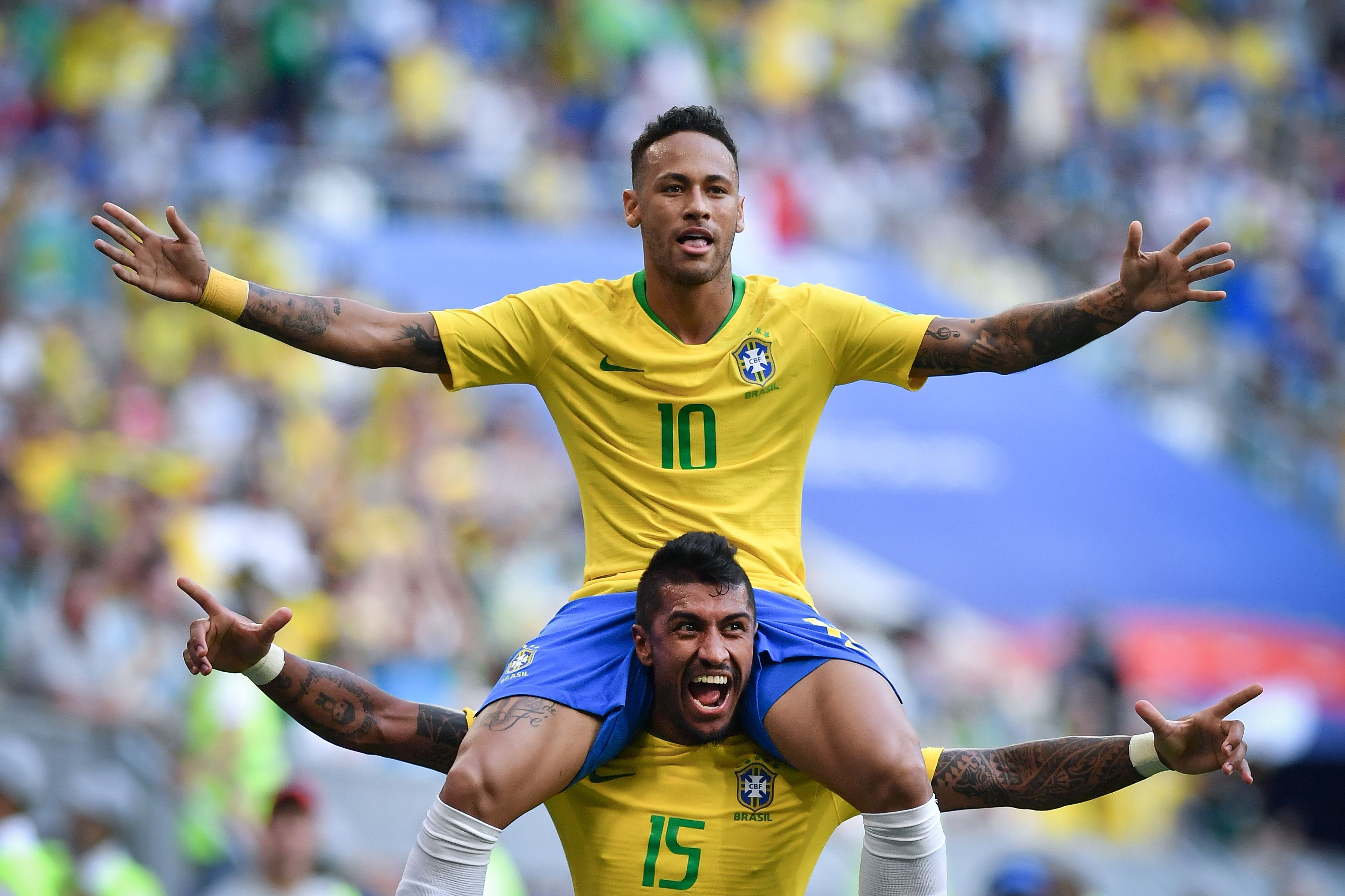 TOPSHOT - Brazil's forward Neymar celebrates with Brazil's midfielder Paulinho after scoring the opening goal during the Russia 2018 World Cup round of 16 football match between Brazil and Mexico at the Samara Arena in Samara on July 2, 2018. (Photo by Fabrice COFFRINI / AFP)        (Photo credit should read FABRICE COFFRINI/AFP/Getty Images)