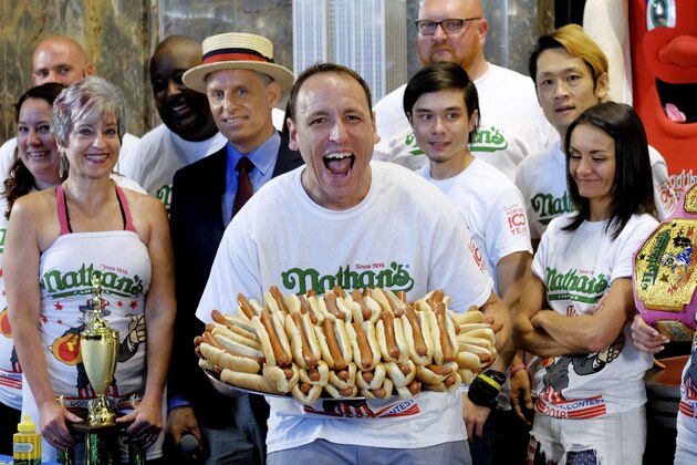 Ten-time and defending Nathan's Famous Men's Champion Joey Chestnut poses with 72 hot dogs during Nathan's Famous International Fourth of July Hot Dog Eating Contest weigh-in at the Empire State Building on Tuesday, July 3, 2018, in New York. (Photo by Evan Agostini/Invision/AP)