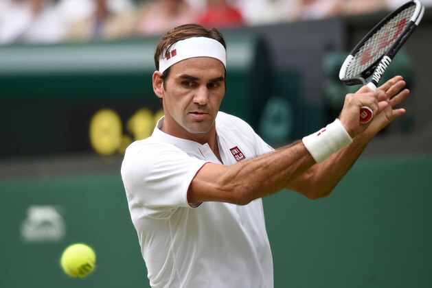 Switzerland's Roger Federer returns against Slovakia's Lukas Lacko during their men's singles second round match on the third day of the 2018 Wimbledon Championships at The All England Lawn Tennis Club in Wimbledon, southwest London, on July 4, 2018. (Photo by Oli SCARFF / AFP) / RESTRICTED TO EDITORIAL USE        (Photo credit should read OLI SCARFF/AFP/Getty Images)