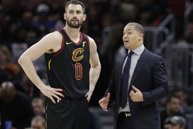 Cleveland Cavaliers coach Tyronn Lue talks with Kevin Love during the second half in Game 4 against the Golden State Warriors in basketball's NBA Finals, Friday, June 8, 2018, in Cleveland. (AP Photo/Tony Dejak)