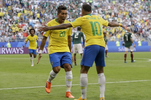 Brazil's Roberto Firmino, left, celebrates with Brazil's Neymar, right, after scoring his side's second goal during the round of 16 match between Brazil and Mexico at the 2018 soccer World Cup in the Samara Arena, in Samara, Russia, Monday, July 2, 2018. (AP Photo/Andre Penner)