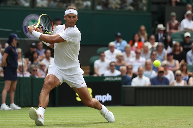 Spain's Rafael Nadal returns to Kazakhstan's Mikhail Kukushkin in their men's singles second round match on the fourth day of the 2018 Wimbledon Championships at The All England Lawn Tennis Club in Wimbledon, southwest London, on July 5, 2018. (Photo by Daniel LEAL-OLIVAS / AFP) / RESTRICTED TO EDITORIAL USE        (Photo credit should read DANIEL LEAL-OLIVAS/AFP/Getty Images)