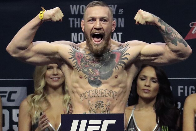 FILE - In this Friday, Nov. 11, 2016, file photo, Conor McGregor stands on a scale during the weigh-in event for his fight against Eddie Alvarez in UFC 205 mixed martial arts at Madison Square Garden in New York. UFC President Dana White says he’s unsure how long Connor McGregor can keep his lightweight title without defending it. White told The Associated Press, “that’s what we have to figure out,” in a telephone interview, Thursday, Nov. 30, 2017, days before UFC 218 in Detroit. (AP Photo/Julio Cortez, File)