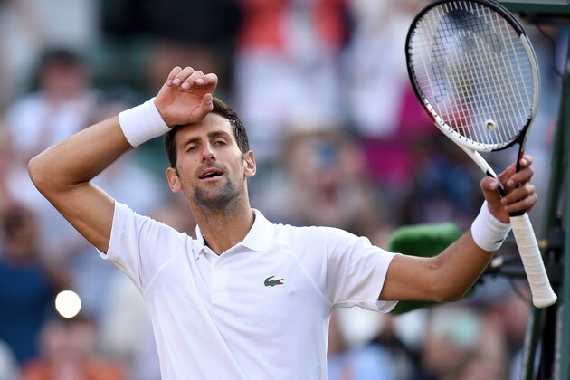 Serbia's Novak Djokovic reacts after winning against US Player Tennys Sandgren during their men's singles first round match on the second day of the 2018 Wimbledon Championships at The All England Lawn Tennis Club in Wimbledon, southwest London, on July 3, 2018. - Djokovic won the match 6-3, 6-1, 6-2. (Photo by Oli SCARFF / AFP) / RESTRICTED TO EDITORIAL USE        (Photo credit should read OLI SCARFF/AFP/Getty Images)