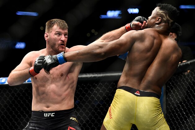 BOSTON, MA - JANUARY 20:  (L-R) Stipe Miocic punches Francis Ngannou of Cameroon in their heavyweight championship bout during the UFC 220 event at TD Garden on January 20, 2018 in Boston, Massachusetts. (Photo by Brandon Magnus/Zuffa LLC/Zuffa LLC via Getty Images)