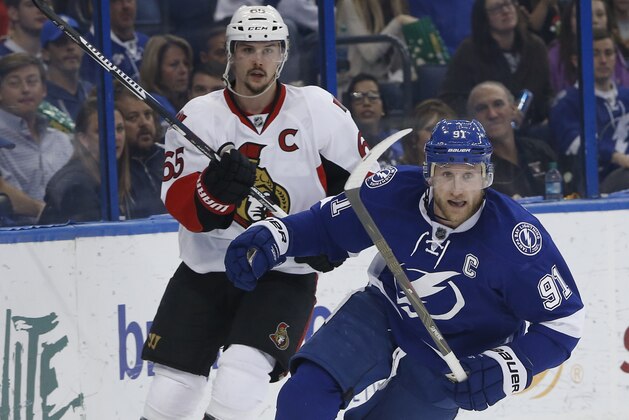 Tampa Bay Lightning center Steven Stamkos (91) skates against Ottawa Senators defenseman Erik Karlsson (65), of Sweden, during the second period of an NHL hockey game, Sunday, Dec. 20, 2015, in Tampa, Fla. (AP Photo/Brian Blanco)