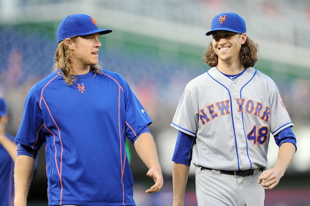 WASHINGTON, DC - SEPTEMBER 12:  Noah Syndergaard #34 and Jacob deGrom #48 of the New York Mets walk to the dugout before the game against the Washington Nationals at Nationals Park on September 12, 2016 in Washington, DC. (Photo by G Fiume/Getty Images)