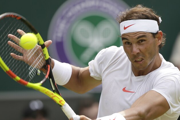 Rafael Nadal of Spain returns the ball to Mikhail Kukushkin of Kazakhstan, during their men's singles match, on the fourth day of the Wimbledon Tennis Championships in London, Thursday July 5, 2018. (AP Photo/Tim Ireland)