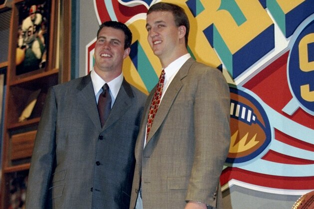 18 Apr 1998:  Second overall pick Ryan Leaf (L) poses alongside first overall pick Peyton Manning (R) during the first round of the 1998 NFL Draft at Madison Square Garden in Manhattan, New York. Mandatory Credit: Jamie Squire  /Allsport