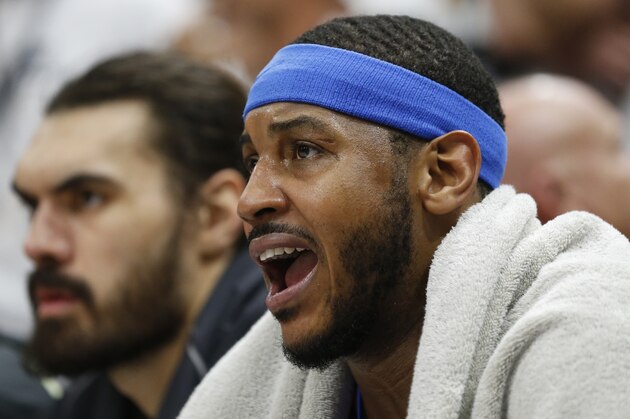 Oklahoma City Thunder forward Carmelo Anthony, right, shouts to his teammates as he sits on the bench in the second half during Game 4 of an NBA basketball first-round playoff series against the Utah Jazz Monday, April 23, 2018, in Salt Lake City. (AP Photo/Rick Bowmer)