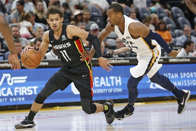 Utah Jazz guard Trey Lewis (34) defends against Atlanta Hawks guard Trae Young (11) during the first half of an NBA summer league basketball game Thursday, July 5, 2018, in Salt Lake City. (AP Photo/Rick Bowmer)