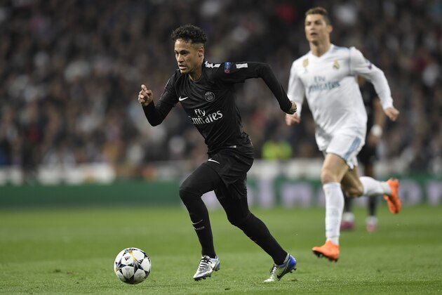 Paris Saint-Germain's Brazilian forward Neymar (L) runs with the ball in front of Real Madrid's Portuguese forward Cristiano Ronaldo (R) during the UEFA Champions League round of sixteen first leg football match Real Madrid CF against Paris Saint-Germain (PSG) at the Santiago Bernabeu stadium in Madrid on February 14, 2018.   / AFP PHOTO / GABRIEL BOUYS        (Photo credit should read GABRIEL BOUYS/AFP/Getty Images)