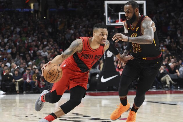 Portland Trail Blazers guard Damian Lillard drives to the basket past Cleveland Cavaliers forward LeBron James during the second half of an NBA basketball game in Portland, Ore., Thursday, March 15, 2018. The Blazers won 113-105. (AP Photo/Steve Dykes)