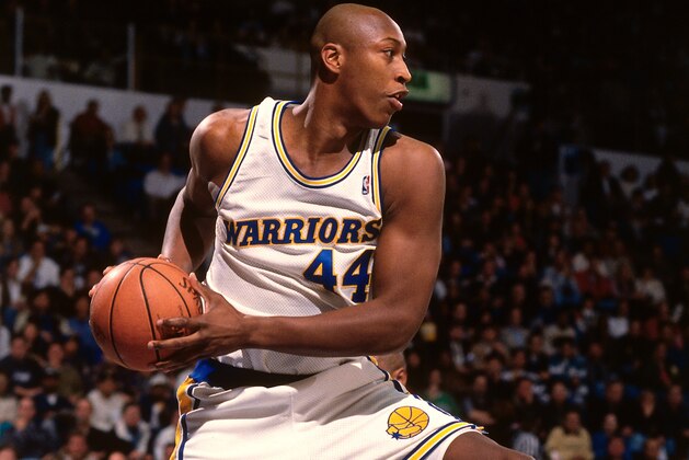 OAKLAND, CA - 1995: Clifford Rozier #44 of the Golden State Warriors rebounds against the Washington Bullets during a game played circa 1995 at the Oakland Coliseum in Oakland, California. NOTE TO USER: User expressly acknowledges and agrees that, by downloading and or using this photograph, User is consenting to the terms and conditions of the Getty Images License Agreement. Mandatory Copyright Notice: Copyright 1995 NBAE (Photo by Brad Mangin/NBAE via Getty Images)