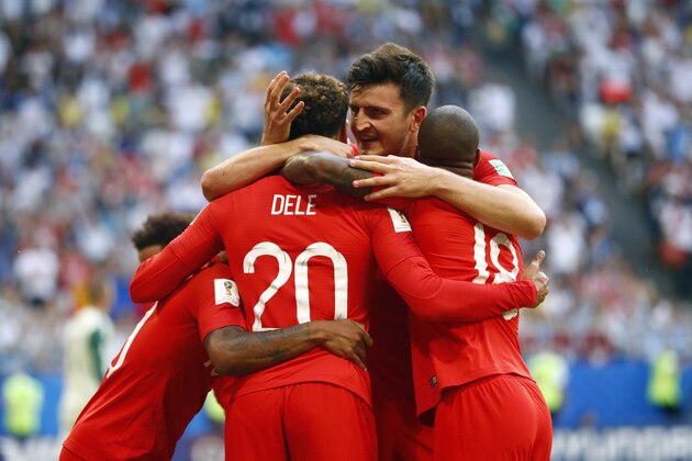 England's Dele Alli, left, celebrates with England's Harry Maguire, center and England's Marcus Rashford, right, after scoring his side's second goal during the quarterfinal match between Sweden and England at the 2018 soccer World Cup in the Samara Arena, in Samara, Russia, Saturday, July 7, 2018. (AP Photo/Matthias Schrader )