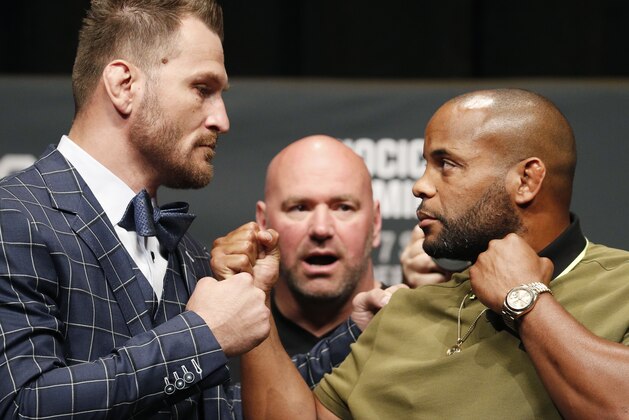Stipe Miocic, left, and Daniel Cormier pose during a news conference for UFC 226, Thursday, July 5, 2018, in Las Vegas. The two are scheduled to fight in a heavyweight title fight Saturday in Las Vegas. (AP Photo/John Locher)