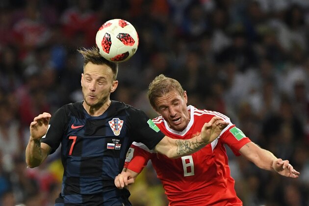 Croatia's midfielder Ivan Rakitic (L) and Russia's midfielder Yuri Gazinskiy vie for the ball during the extra time of the Russia 2018 World Cup quarter-final football match between Russia and Croatia at the Fisht Stadium in Sochi on July 7, 2018. (Photo by Kirill KUDRYAVTSEV / AFP) / RESTRICTED TO EDITORIAL USE - NO MOBILE PUSH ALERTS/DOWNLOADS        (Photo credit should read KIRILL KUDRYAVTSEV/AFP/Getty Images)